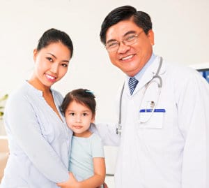 portrait of mother and daugther with doctor smiling